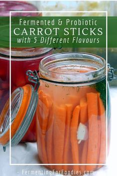 several jars filled with carrot sticks on top of a table