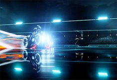 a person riding a motorcycle in the middle of a race track at night with bright lights