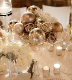 a glass bowl filled with ornaments on top of a table