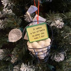 an ornament hanging from a christmas tree that says it takes a lot of balls to play the way i do