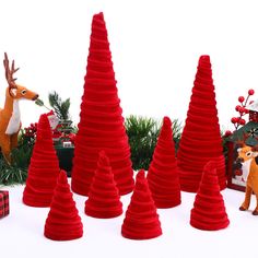 a group of red christmas trees sitting next to each other