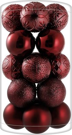 a stack of red christmas balls sitting on top of each other