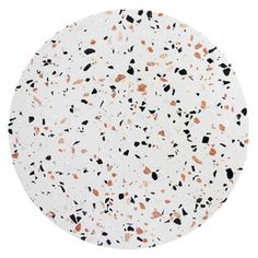 a white plate with black and orange speckles on the top, against a white background