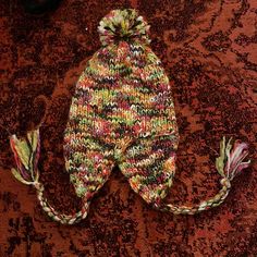 Selling This Super Cute Multicolored Knitted Hat With Ear Covers, Hanging Tassels And A Top Pom. Never Worn, In Excellent Condition. Fits Adult Head, Uni-Sex And One-Size. From A Pet Free, Smoke Free Home. Hanging Tassels, Ear Hats, Knitted Hat, Knit Hat, Knitted Hats, Tassels, Pom Pom, Super Cute, Womens Sizes