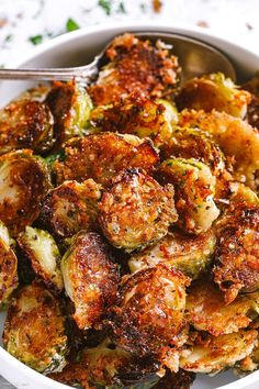 a white bowl filled with cooked brussel sprouts