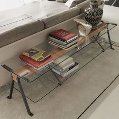 a glass coffee table with books on it