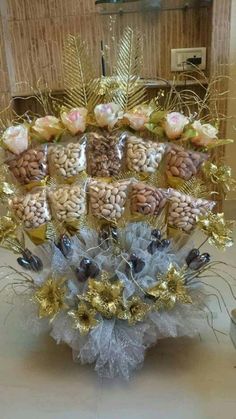 a vase filled with lots of different types of nuts and other things on top of a table