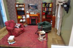 a living room filled with furniture and lots of books on top of a red rug