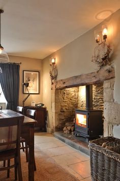 a living room with a fire place next to a dining table