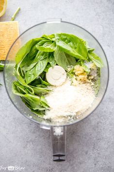 spinach and other ingredients in a food processor ready to be blended into breadcrumbs