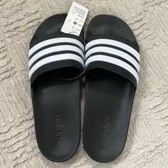 Adidas Size 12 Black White Adilette Shower Shoes Sandals Slides Black With White Stripes Wear These Adidas Adilette Men's Shower Slide Sandals Around Your House Or Out On The Town. One-Piece Synthetic Upper With 3-Stripe Detail Offers A Stylish Old School Look While A Cloudfoam Footbed Provides Extra Padding For Improved Comfort And Feel. The Adidas Adilette Cloudfoam Slide Has An Injected Eva Outsole That Delivers Maximum Comfort That Can Be Enjoyed All Day Long. Shoe Features Three Stripe Bran Adidas Black Slides For Summer, Black Adidas Sandals For Summer, Adidas Non-slip Slip-on Sandals, Adidas Black Synthetic Flip Flops, Adidas Flat Non-slip Sandals, Adidas Non-slip Flat Sandals, Adidas Flat Synthetic Sandals, Adidas Open Toe Sandals With Cushioned Footbed, Casual Black Adidas Flip Flops