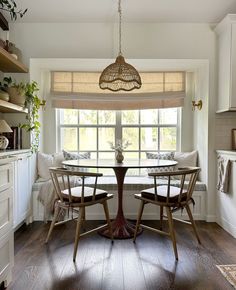 a dining room table with four chairs around it