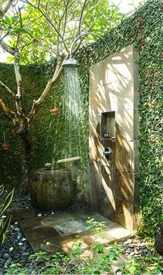 an outdoor shower in the middle of a garden