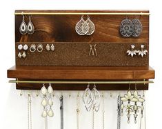 a wall mounted jewelry rack with earrings on it