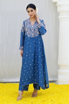 Jean blue kurta features a heavily embroidered jaal on the yoke enhanced with organza rosettes, sprinkled with dori dots all over. Paired with embroidered palazzo.
Components: 2
Pattern: Embroidered
Type Of Work: Resham
Neckline: Cutwork
Sleeve Type: Long
Fabric: Banaras Silk Base
Color: Blue
Other Details: 
Lace detail
Floral applique
Note: Kindly contact customer service for embroidered dupatta
Occasion: Mehendi and Haldi - Aza Fashions Blue Chikankari Embroidered Dress With Traditional Drape, Blue Anarkali Set With Floral Embroidery, Blue Embroidered Dress With Dabka Work For Wedding, Blue Chikankari Embroidered Georgette Fabric, Blue Embroidered Zari Work Designer Dress, Blue Embroidered Zari Work Dress For Designer Wear, Blue Embroidered Fabric For Anarkali Suits With Resham Embroidery, Designer Blue Embroidered Dress With Zari Work, Blue Anarkali Embroidered Fabric With Resham Embroidery