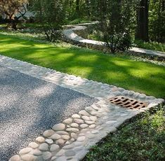 there is a stone walkway in the middle of some grass and rocks on the ground