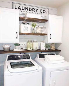 a white washer and dryer sitting in a laundry room next to each other