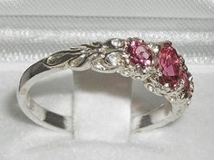 *This lovely ring is made from 375 9K White Gold with Genuine Natural Semi-precious Pink Tourmalines.*Total gem weight: 0.9ctGenuine Natural Pink Tourmaline - One center oval cut 6x4 mm (0.24" x 0.16") and two round cut 4mm (0.16") Pretty Pink Tourmalines set in this Solid 9K White Gold Victorian style setting.*Total Height 3mm, Width 20mm, Length 7mmCompletely made from Solid 9K Gold Hallmarked by the London Assay Office which confirms the rings authenticity. The Hallmark includes the 375 marki Gold Ring Pink Stone, Pink Stone Wedding Ring, Pink And Silver Ring, Pink And Green Ring, Tourmaline Three-stone Ring As A Gift, Tourmaline Three-stone Ring Perfect For Gifting, Tourmaline Three Stone Ring Perfect As A Gift, Tourmaline Three-stone Ring For Gift, Pink Three Stone Promise Ring