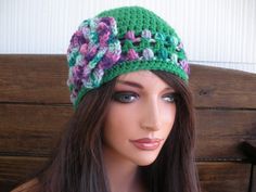 NEW - Winter Fashion Crochet Hat with with Flower. Kelly green crochet hat with multicolored stripes and flower - Women / Teen hat - Winter fashion hat. MATERIALS: Acrylic yarn - Kelly green and multicolored yarn Women / Teen size ONE SIZE SIZE: 22 "  inches circumference when stretch 4  1/2  " inches diameter crochet flower Care instructions: Hand wash. Lay flat to dry. Air dry only. Green Spring Hat, One Size Fits Most, Green Spring Hat One Size Fits Most, Whimsical Green Yarn Hats, Spring Green Hat, Handmade Beanie For Spring, Adjustable Brimmed Green Beanie, Handmade Spring Beanie Hat, Green Crochet Hat Made Of Yarn, Handmade Spring Beanie