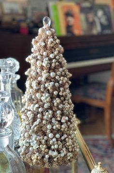 a small christmas tree sitting on top of a table next to other decorations and bottles