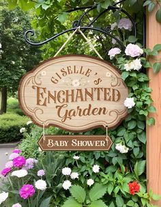 a wooden sign hanging from the side of a building next to flowers and plants in front of it