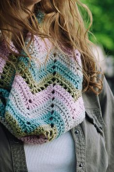 a close up of a person wearing a knitted scarf