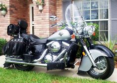 a black and silver motorcycle parked in front of a house