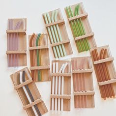 there are many different types of straws in the wooden box on the table together