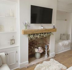 a flat screen tv mounted above a fireplace in a living room