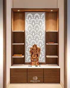 a wooden shelf with a statue on top of it in front of a white wall