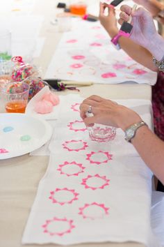 two women are doing crafts at a table