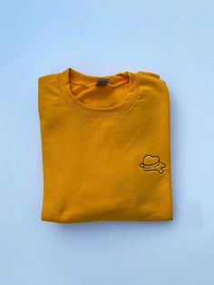 JUST RESTOCKED :) Premium embroidered crewneck sweatshirt. Made with a classy triad of colors, the design is embroidered onto a high quality butter-yellow crewneck. Please refer to the size guide in the listing for sweatshirt measurements. If you have any questions, please feel free to message me :) If there's a specific size+color you would like but it's out of stock, please message us! I'll try my best to accommodate :) Comes with freebies :) Casual Yellow Embroidered T-shirt, Yellow Casual T-shirt With Embroidered Graphics, Casual Yellow Tops With Embroidered Graphics, Yellow Cotton Top With Embroidered Logo, Yellow Crew Neck Sweatshirt For Spring, Yellow Crew Neck Relaxed Fit Sweatshirt, Yellow Relaxed Fit Crew Neck Sweatshirt, Mustard Cotton Sweatshirt For Fall, Yellow Crew Neck Tops With Embroidered Logo