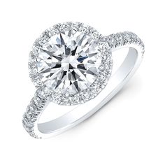 a white gold engagement ring with diamonds on the band and an oval center stone surrounded by round