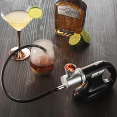 a bottle of booze, a cocktail glass and a cord connected to a hook