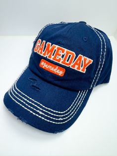 Introducing our Blue/Orange Gameday Ball Cap The perfect blend of sporty style and comfort, designed to make your game day outfit stand out. Whether you're cheering from the stands or running errands, these hats are a must-have for any fan. Key Features: Classic baseball cap design with an adjustable strap for a perfect fit High-quality, durable fabric for long-lasting wear Comfortable fit for all-day wear White stitching on hat gives it a fun look Fast shipping from Texas ensures you’re ready f Navy Snapback Hat For Game Day, Team-colored Cotton Baseball Cap For Game Day, Sports Fan Cap For Game Day, Game Day Cotton Baseball Cap In Team Colors, Team Spirit Baseball Cap For Baseball Season, Blue Snapback Hat For Game Day, Sporty Game Day Trucker Hat With Visor, Casual Blue Baseball Cap For College, Game Day Sports Fan Cap