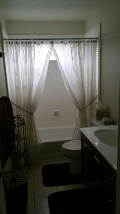 the bathroom is clean and ready to be used as a shower curtain for the tub