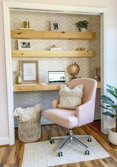 a pink chair sitting in front of a desk with a computer on top of it