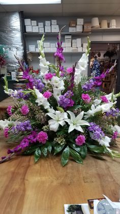 a bouquet of flowers sitting on top of a wooden table