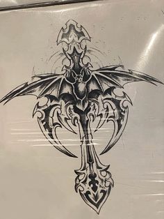 a tattoo design on the side of a white box with an ornate cross and dragon