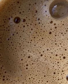 a close up view of the inside of a coffee cup with some brown dots on it