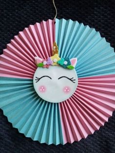 a paper fan with a unicorn face on it