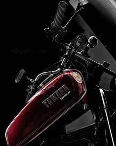 a red motorcycle parked in front of a black background with the words thai on it