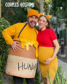 a man and woman dressed up in costumes posing for a photo while standing next to each other