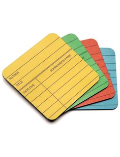 four different colored sticky notes on top of each other