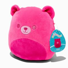 a pink stuffed animal with a tag on it's ear