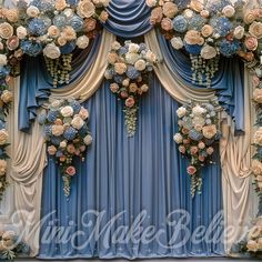 an elaborate blue and gold wedding backdrop with flowers on the stage for a ceremony or special event