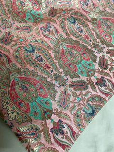 a pink and green paisley print fabric