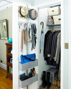 an open closet with shoes and hats hanging on the wall next to a coat rack