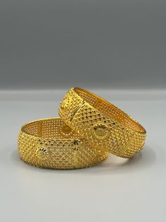 Our 24k Polished Bangles are more than just accessories; they are symbols of grace and beauty, inspired by the rich heritage of Indian, Pakistani, and Nepali jewelry. These stunning bangles showcase the timeless elegance of traditional craftsmanship, perfectly complementing your attire for weddings, festivals, or any special occasion Our company offers expedited Next-Day Delivery Services within the United Kingdom, ensuring prompt and efficient transportation of goods.  Additionally, we strive to extend our shipping capabilities to cater to customers worldwide, aiming to provide the fastest possible shipping methods to international destinations. To ensure the highest standards of hygiene, we kindly request your understanding that all sales are final, and we are unable to accept returns or Yellow Bangle With Intricate Design, Luxury Gold-plated Bangle With Intricate Design, Luxury Gold Plated Bangle With Intricate Design, Festive Yellow Jewelry With Intricate Design, Yellow Gold Bangle With Intricate Design For Formal Occasions, Classic 22k Gold Ceremonial Jewelry, Formal Yellow Gold Bangle With Intricate Design, Formal 22k Gold Hallmarked Bangle, Ceremonial Gold Plated Elegant Bangle