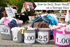 several buckets filled with clothes sitting on the ground next to a sign that says how to sell your stuff at a garage sale